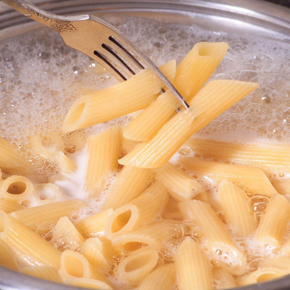 Penne pasta draining