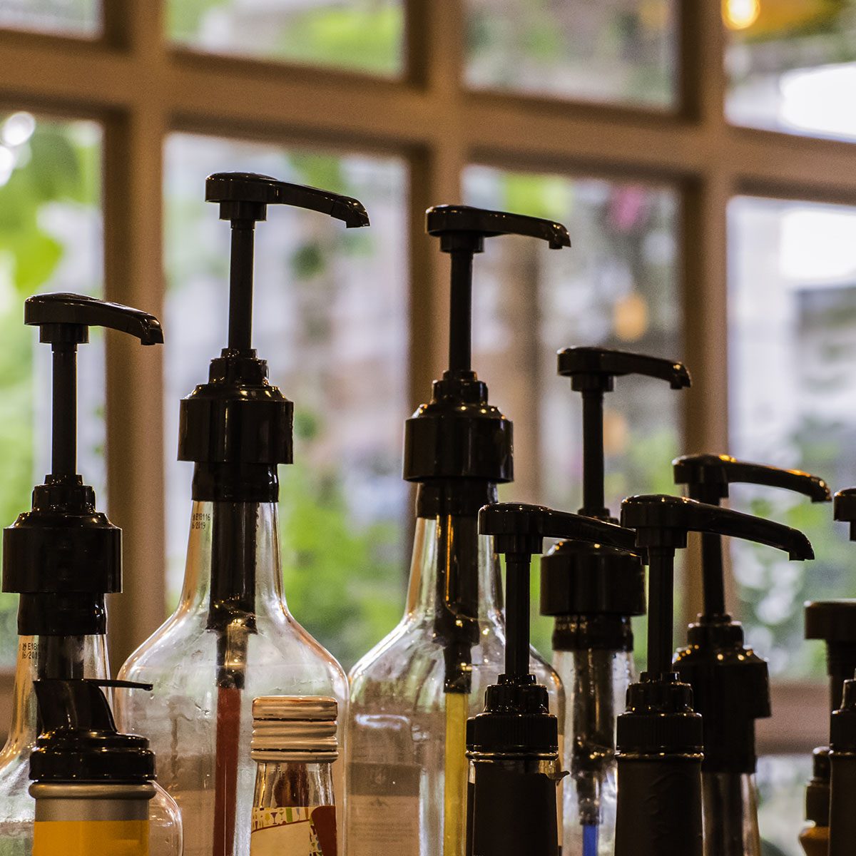 Bottles for syrup in coffee shop.