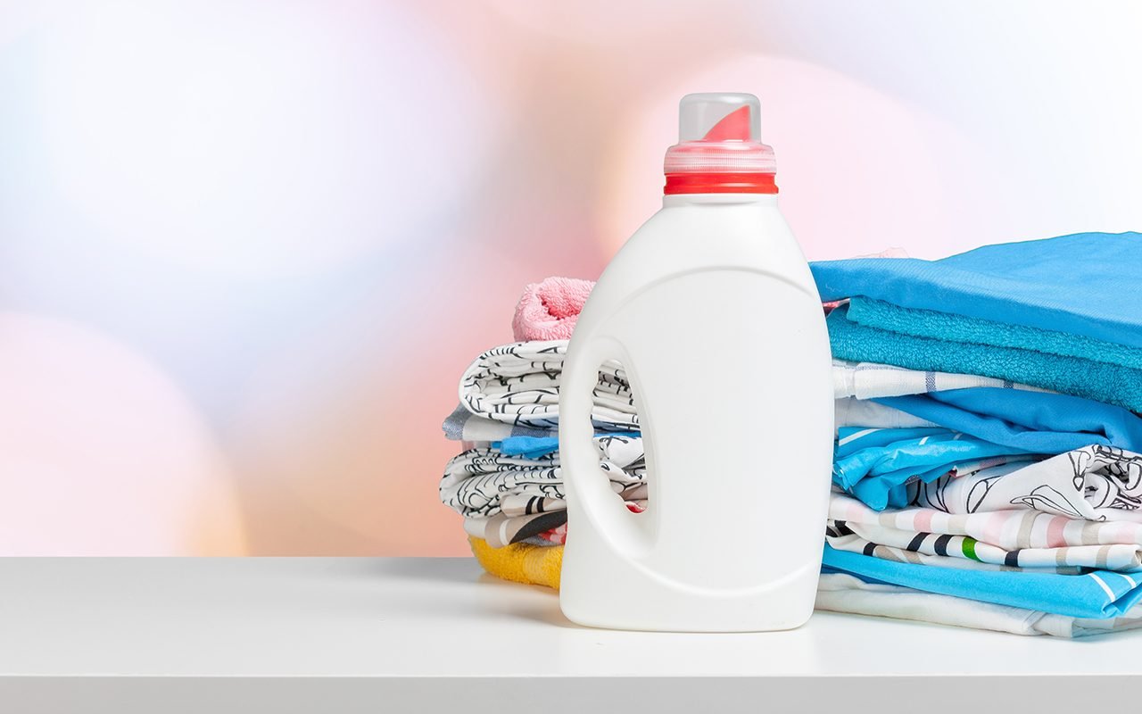 Clean laundry and liquid washing detergent front view