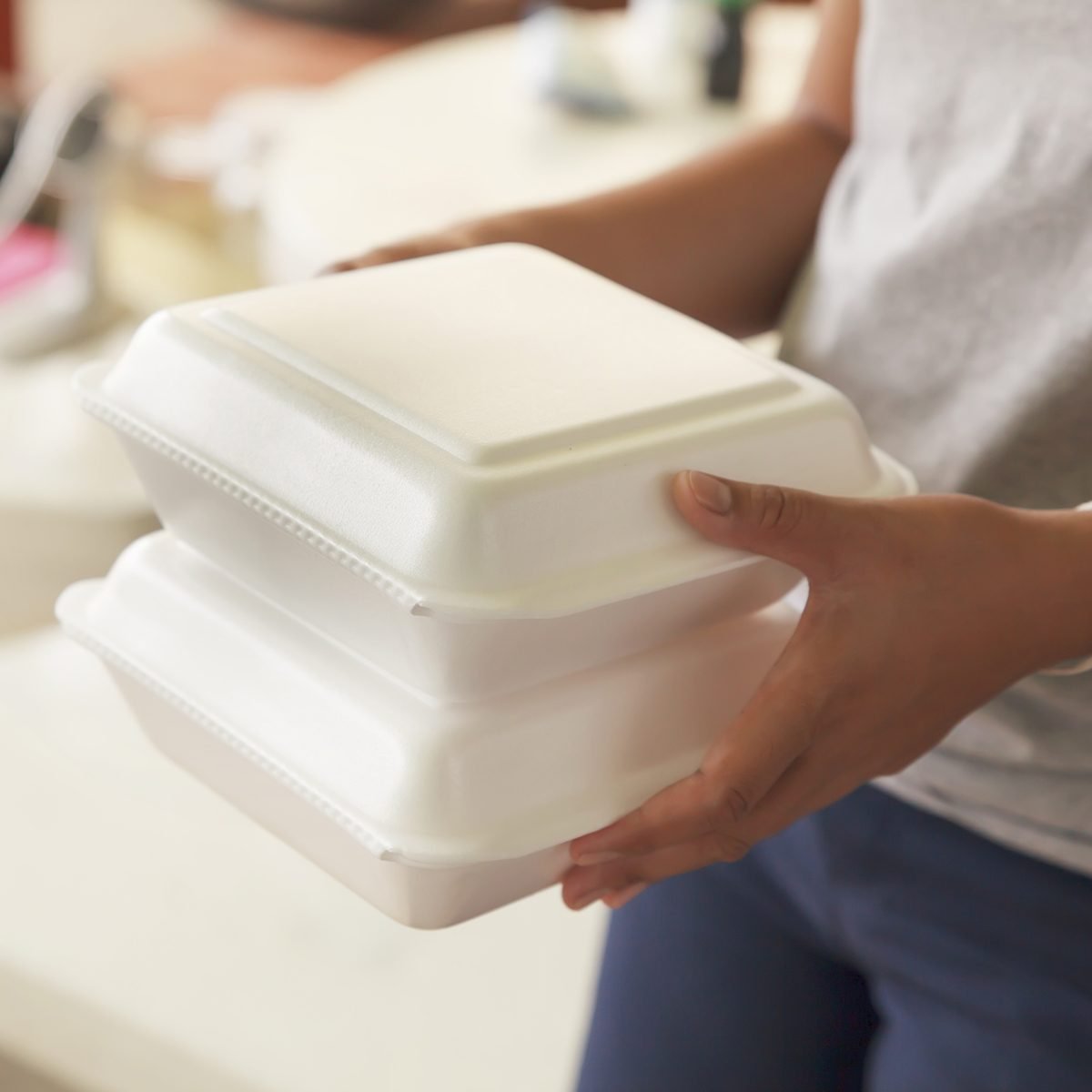 Hand holding foam boxes rice.