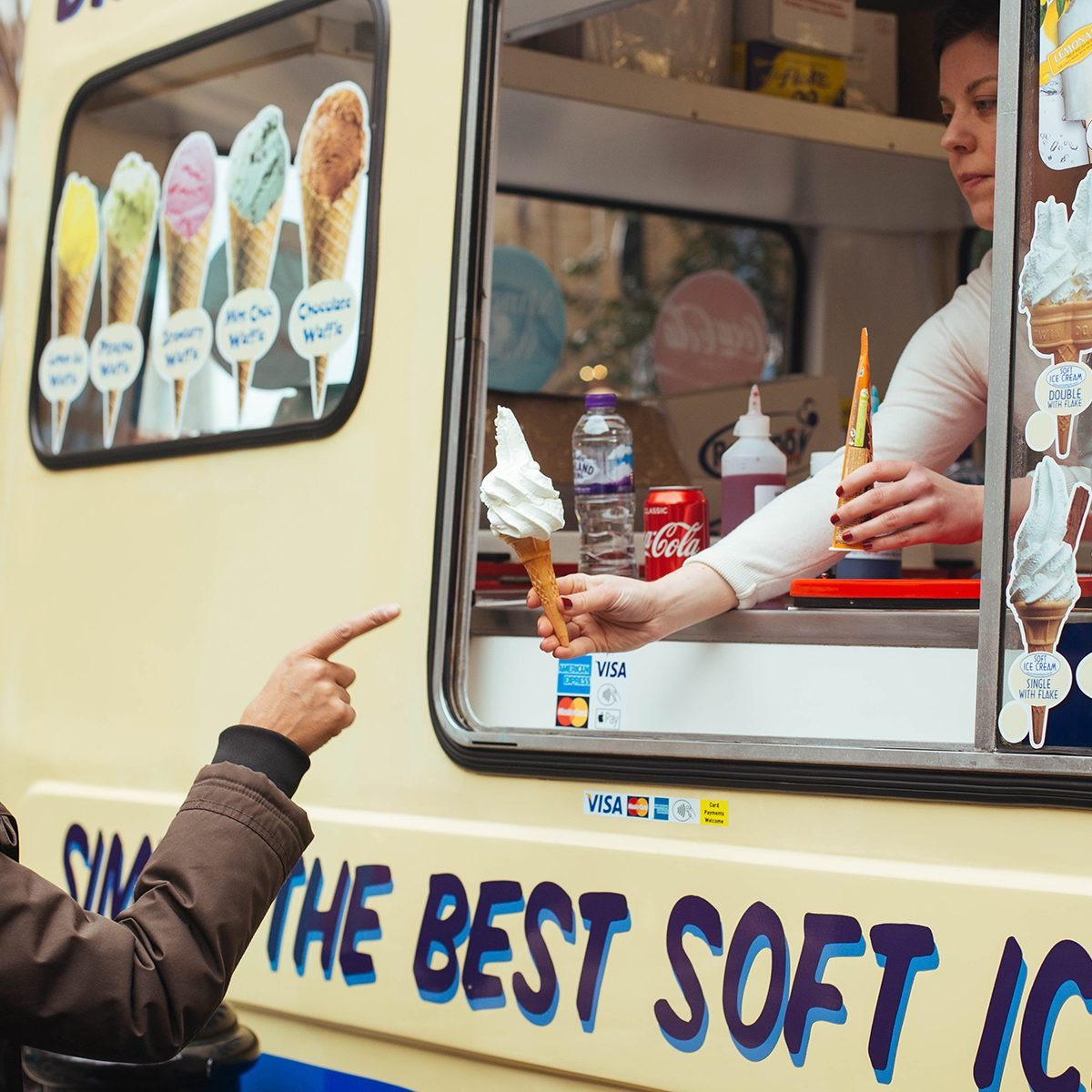 woman buying soft ice cream in the ice cream van near Covent Garden in London