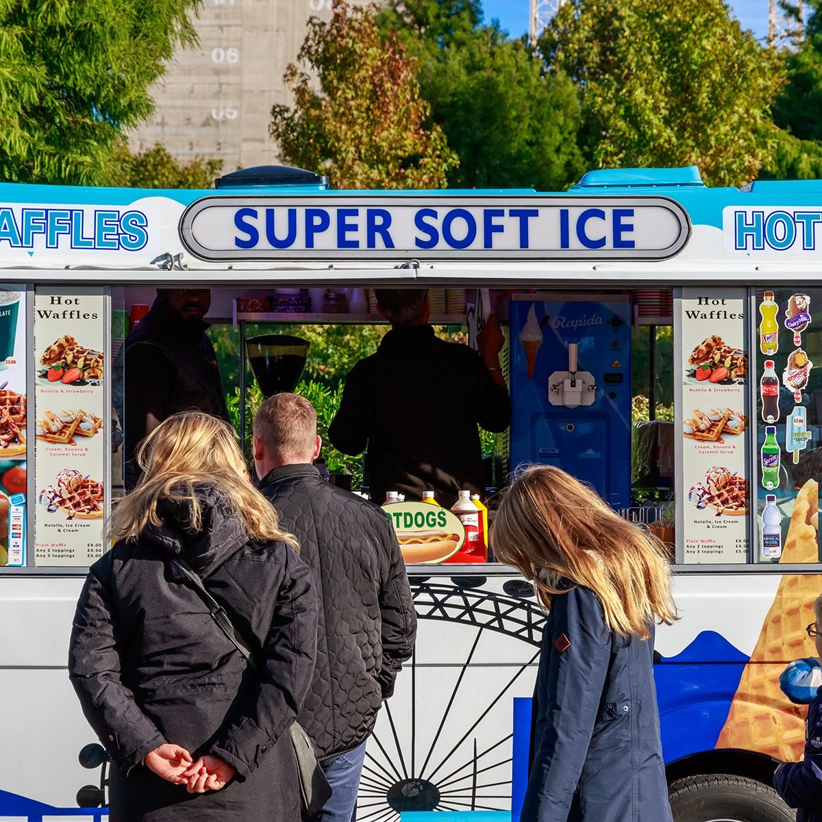 Ice cream van and customers on London street