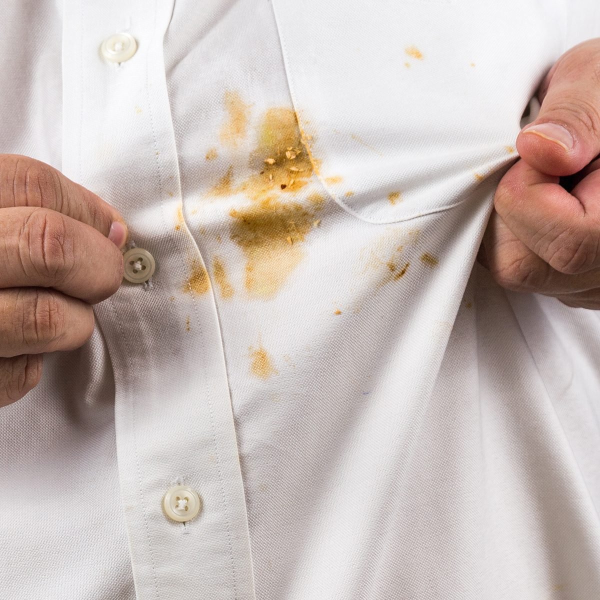 Frustrated person pointing to spilled curry stain on white shirt; Shutterstock ID 1017782002; Job (TFH, TOH, RD, BNB, CWM, CM): TOH