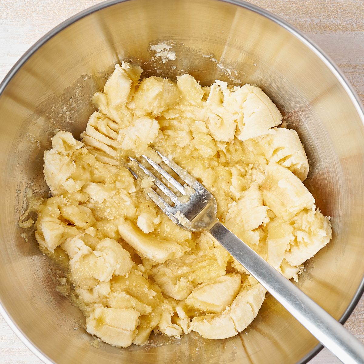 Mashed banana. Step by step recipe. Homemade Banana bread. Top view, white wooden table.; Shutterstock ID 1387758473; Job (TFH, TOH, RD, BNB, CWM, CM): TOH