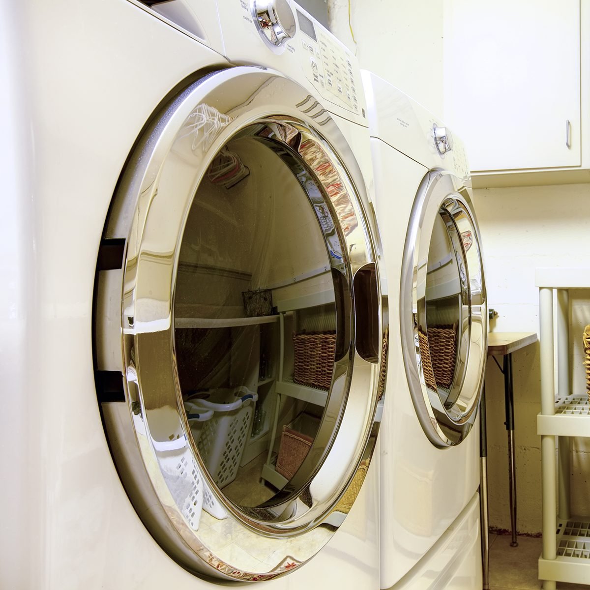 Old style laundry room with modern appliances and wicker baskets