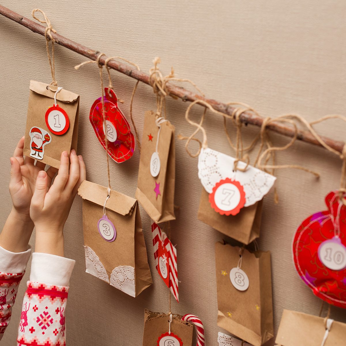 child's hands holding a gift from advent calendar.