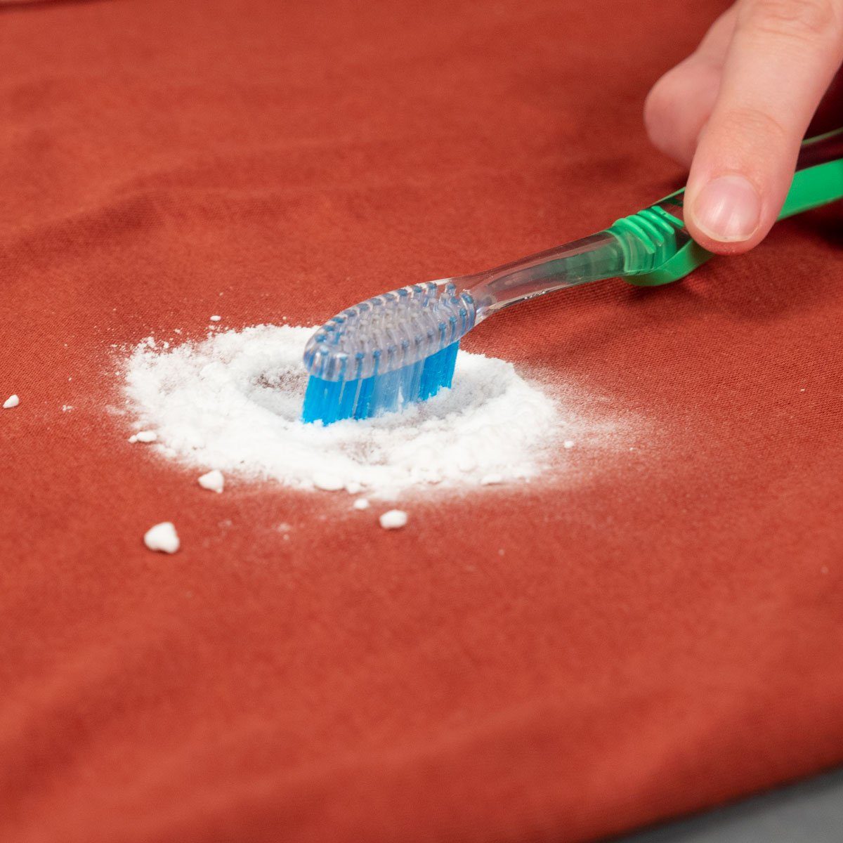 Rubbing baking soda with a tooth brush