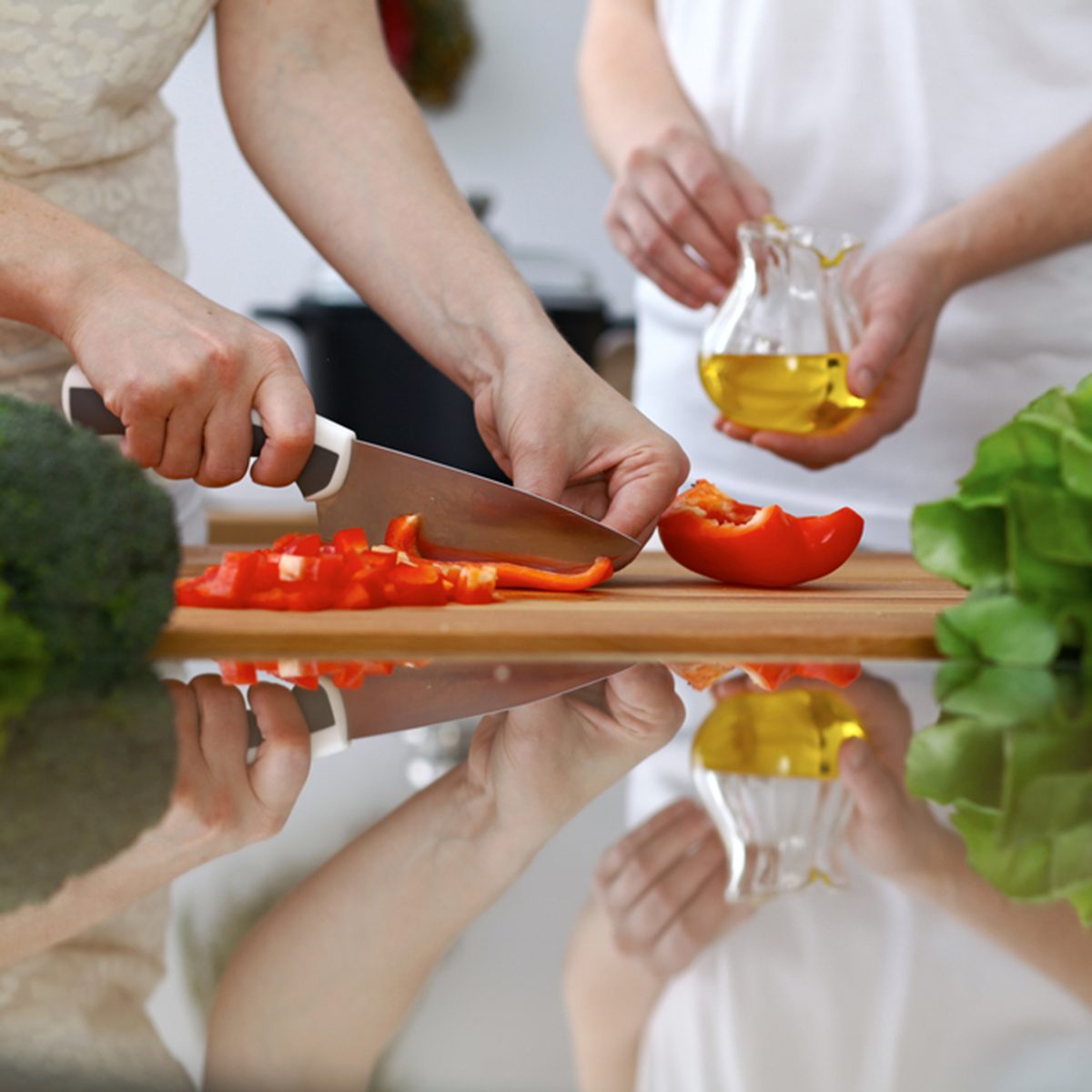 Close-up of human hands cooking in a kitchen.