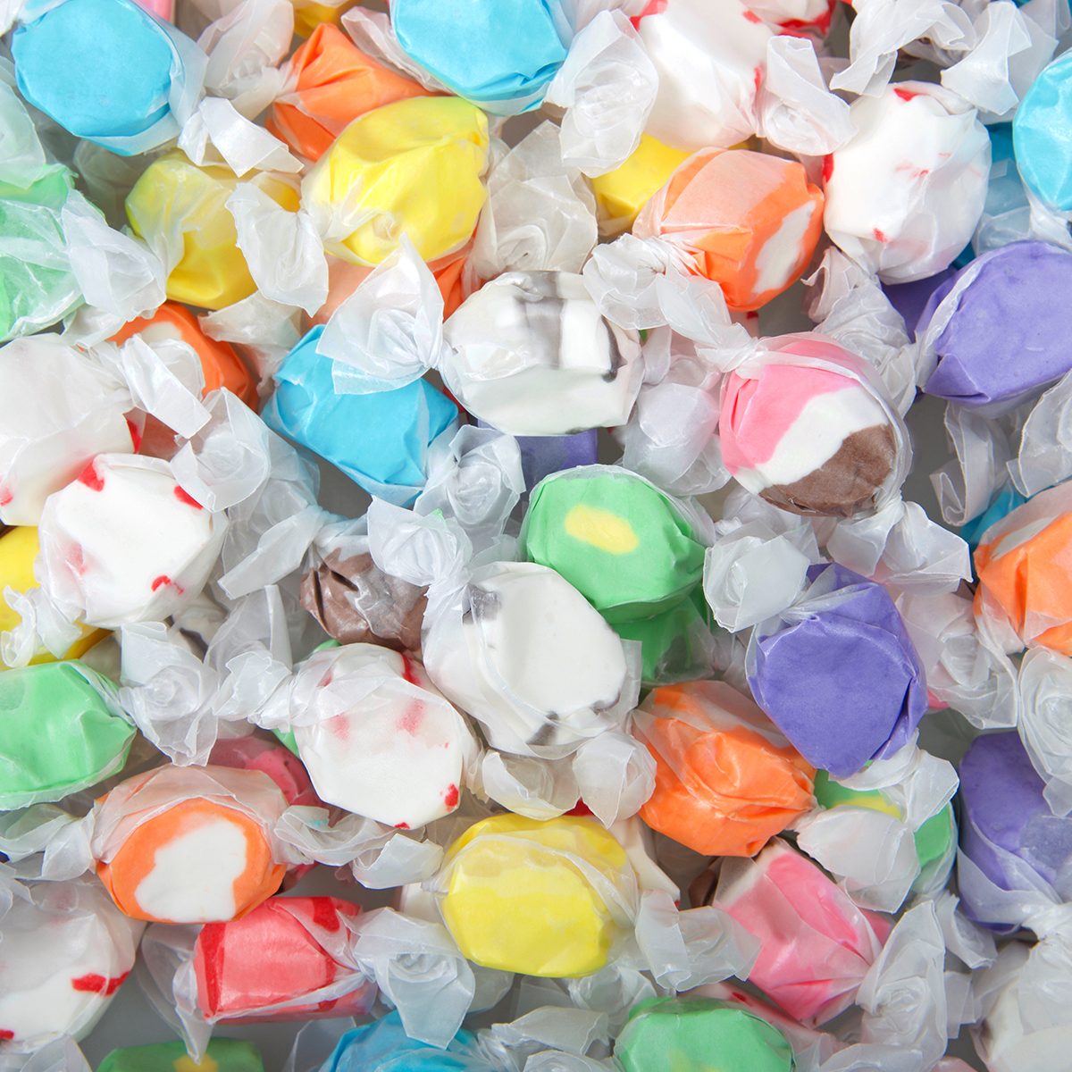 Background of salt water taffy in various flavors and colors wrapped in white transparent paper. Salt water taffy is sold widely on the boardwalks in the U.S. and Canada.; Shutterstock ID 1312539896; Job (TFH, TOH, RD, BNB, CWM, CM): Taste of Home
