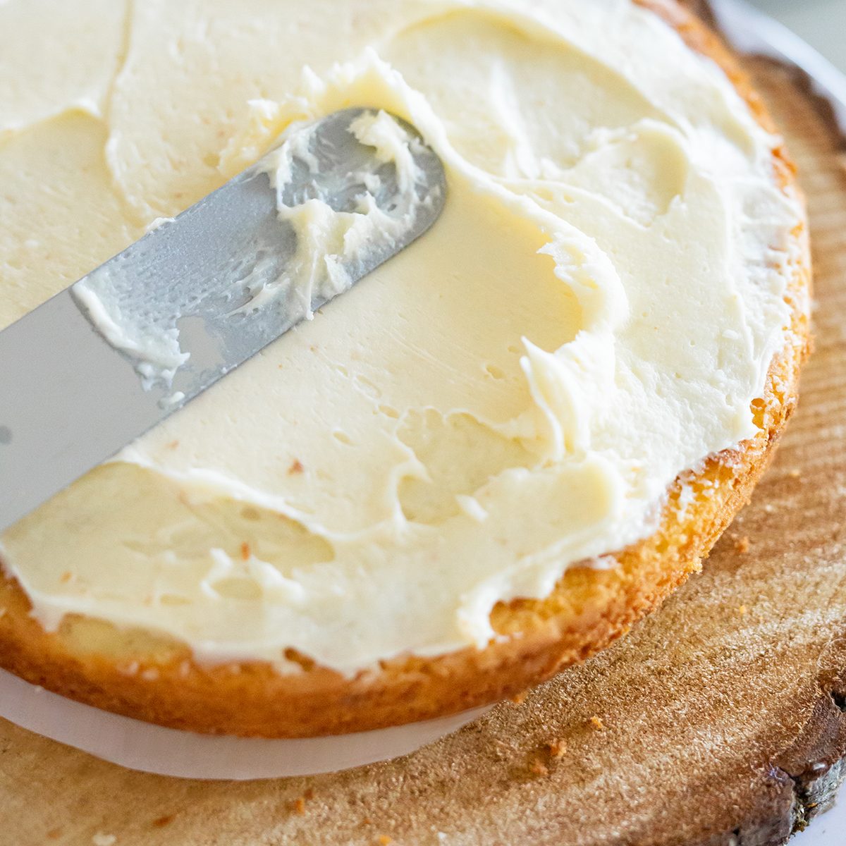 woman icing vanilla cake with metal spatula ; Shutterstock ID 1485154997; Job (TFH, TOH, RD, BNB, CWM, CM): TOH