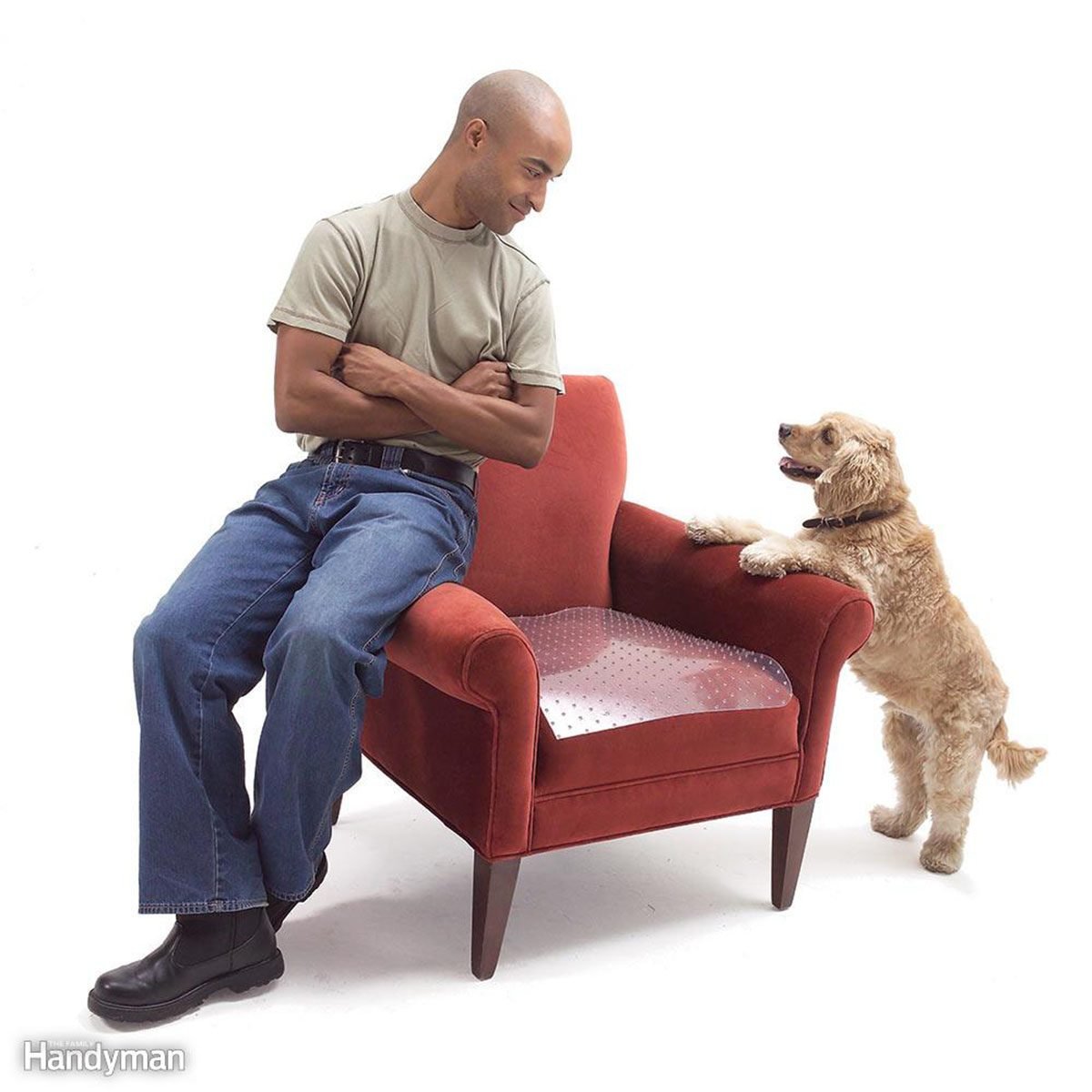 Man and dog sitting on the arms of a chair