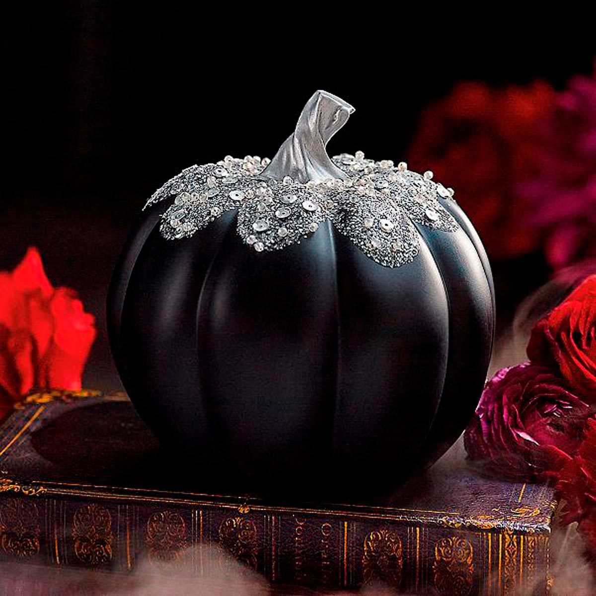 Pumpkin painted all black with silver accent on vine and leafs