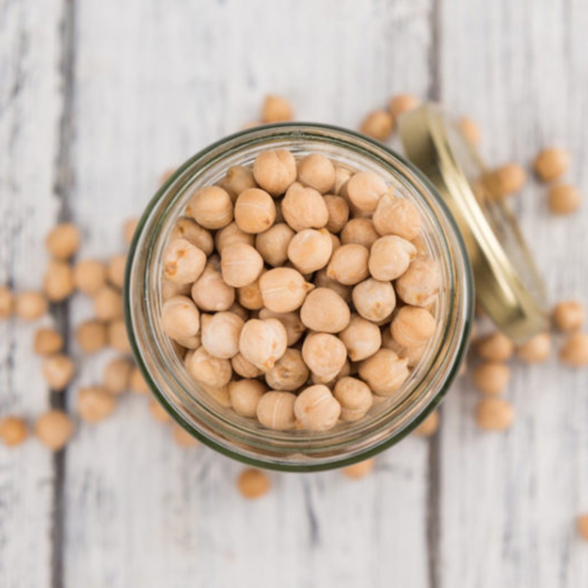 Dried Chickpeas as high detailed close-up shot on a vintage wooden table