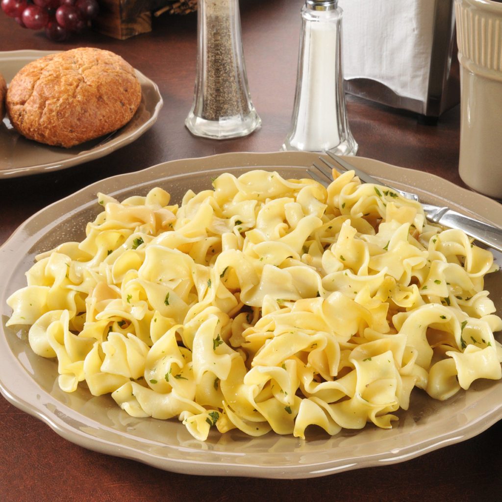 A plate of buttered noodles with dinner rolls; Shutterstock ID 139217111; Job (TFH, TOH, RD, BNB, CWM, CM): Taste of Home