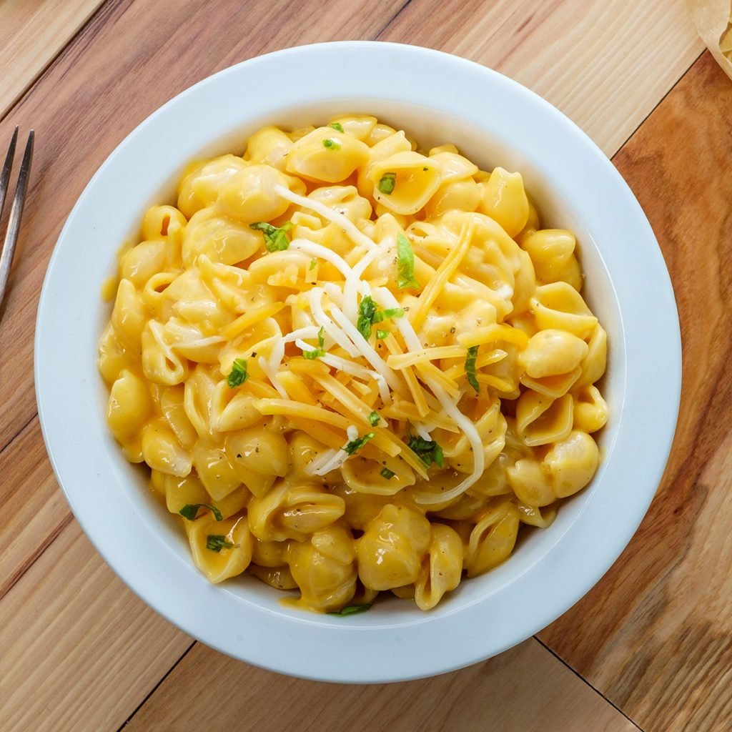 Delicious macaroni and cheddar cheese shell noodles in a bowl; Shutterstock ID 1496072468; Job (TFH, TOH, RD, BNB, CWM, CM): Taste of Home