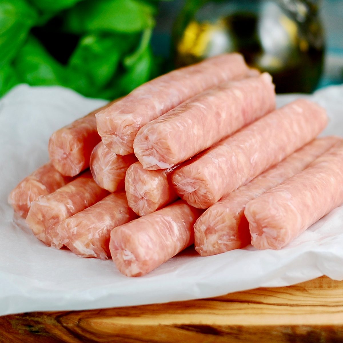 Raw breakfast sausages on a wooden board, uncooked sausages for breakfast ; Shutterstock ID 1507042004; Job (TFH, TOH, RD, BNB, CWM, CM): TOH