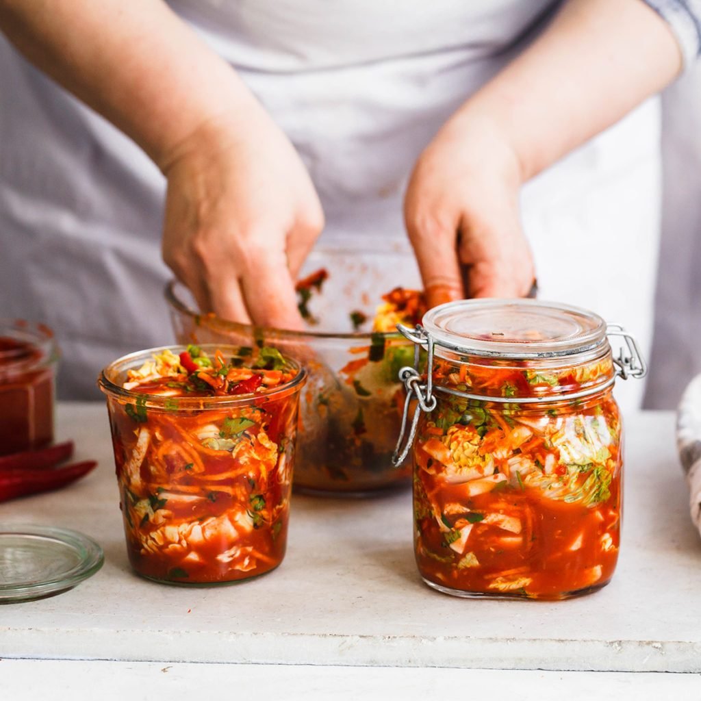 Base Cabbage Kimchi. Person preparing cabbage kimchi. Fermented and vegetarian preserved food concept.; Shutterstock ID 621832271