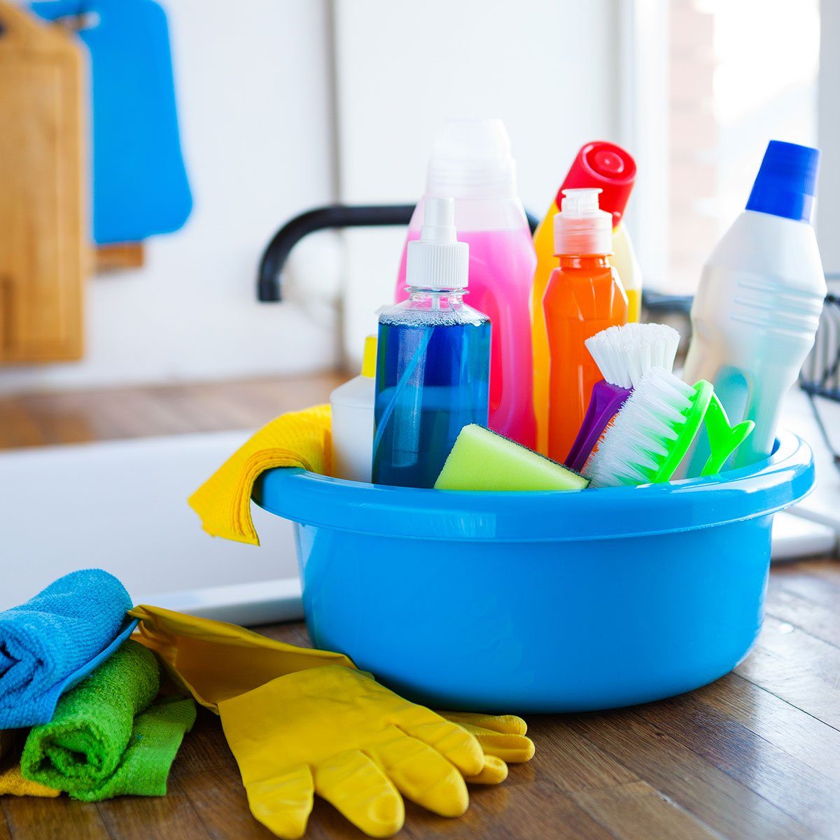 cleaning supplies in a bucket on a countertop