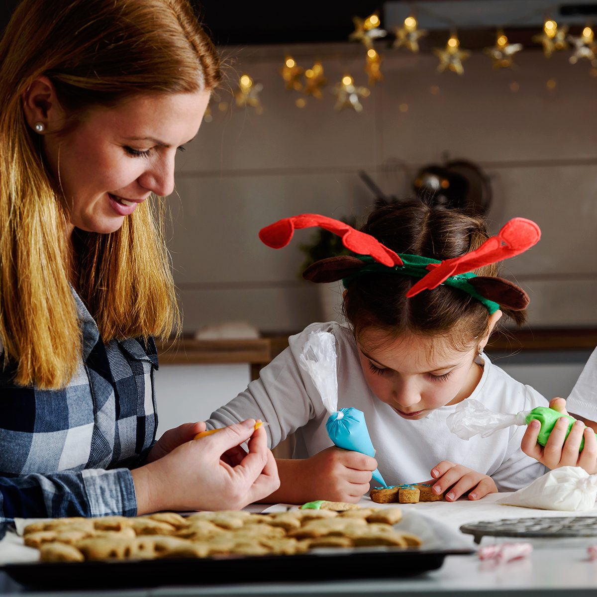 Mother with children baking cookies for Christmas