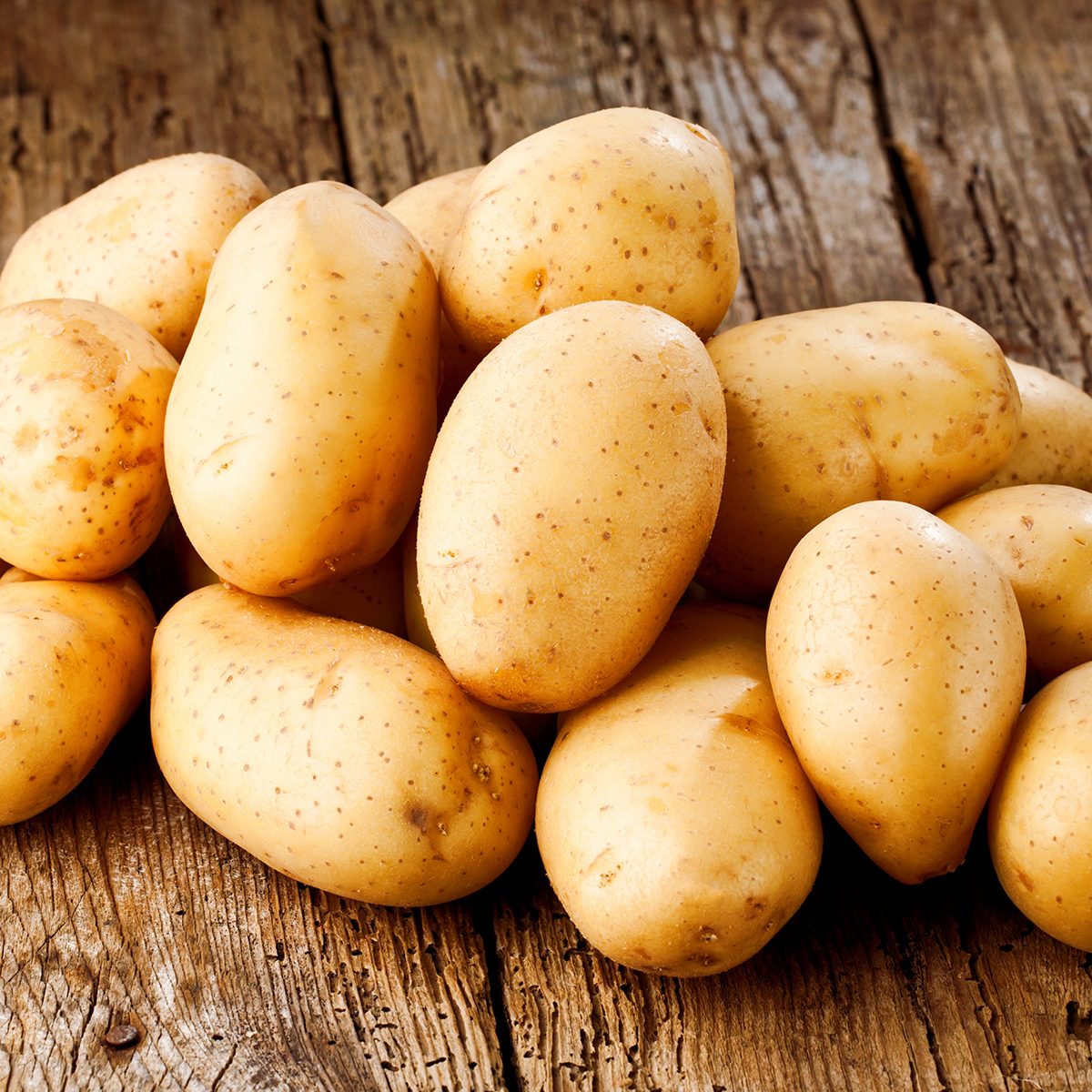 Fresh potatoes on wooden background