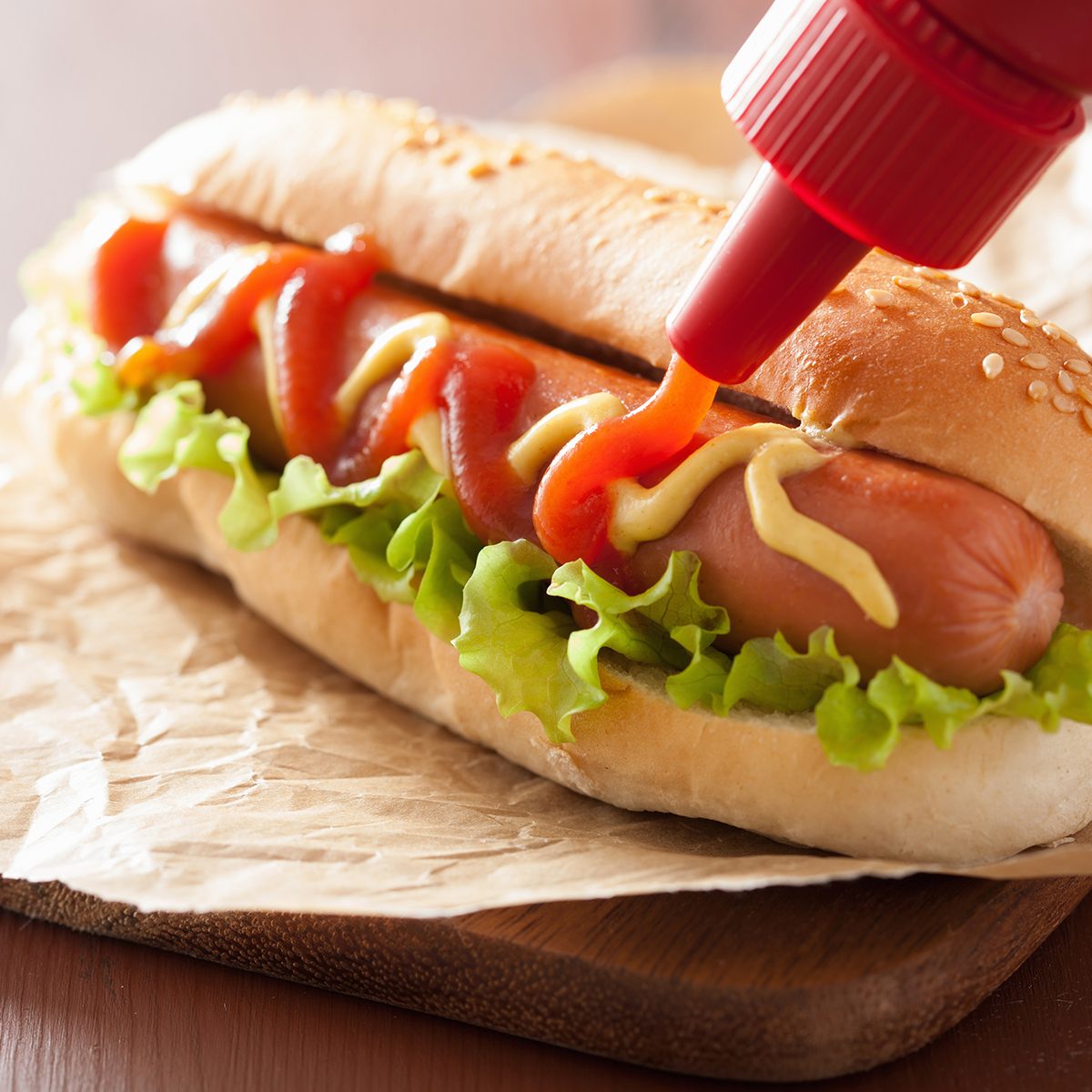 hot dog with ketchup mustard and lettuce