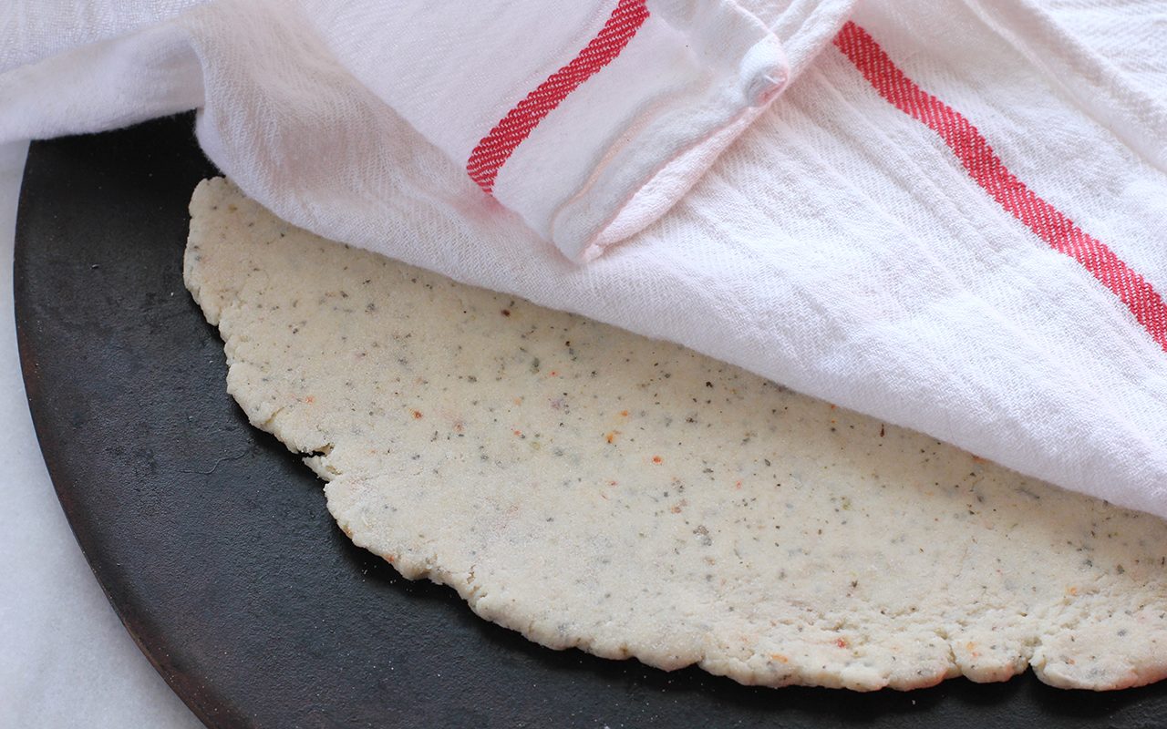 Dough resting under a tea towel