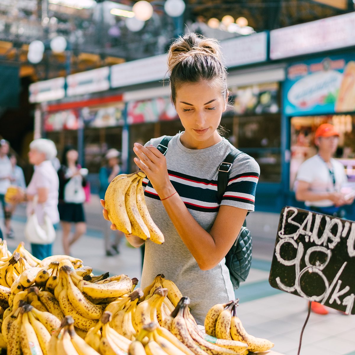 Tourist woman in Budapest buying fresh fruits