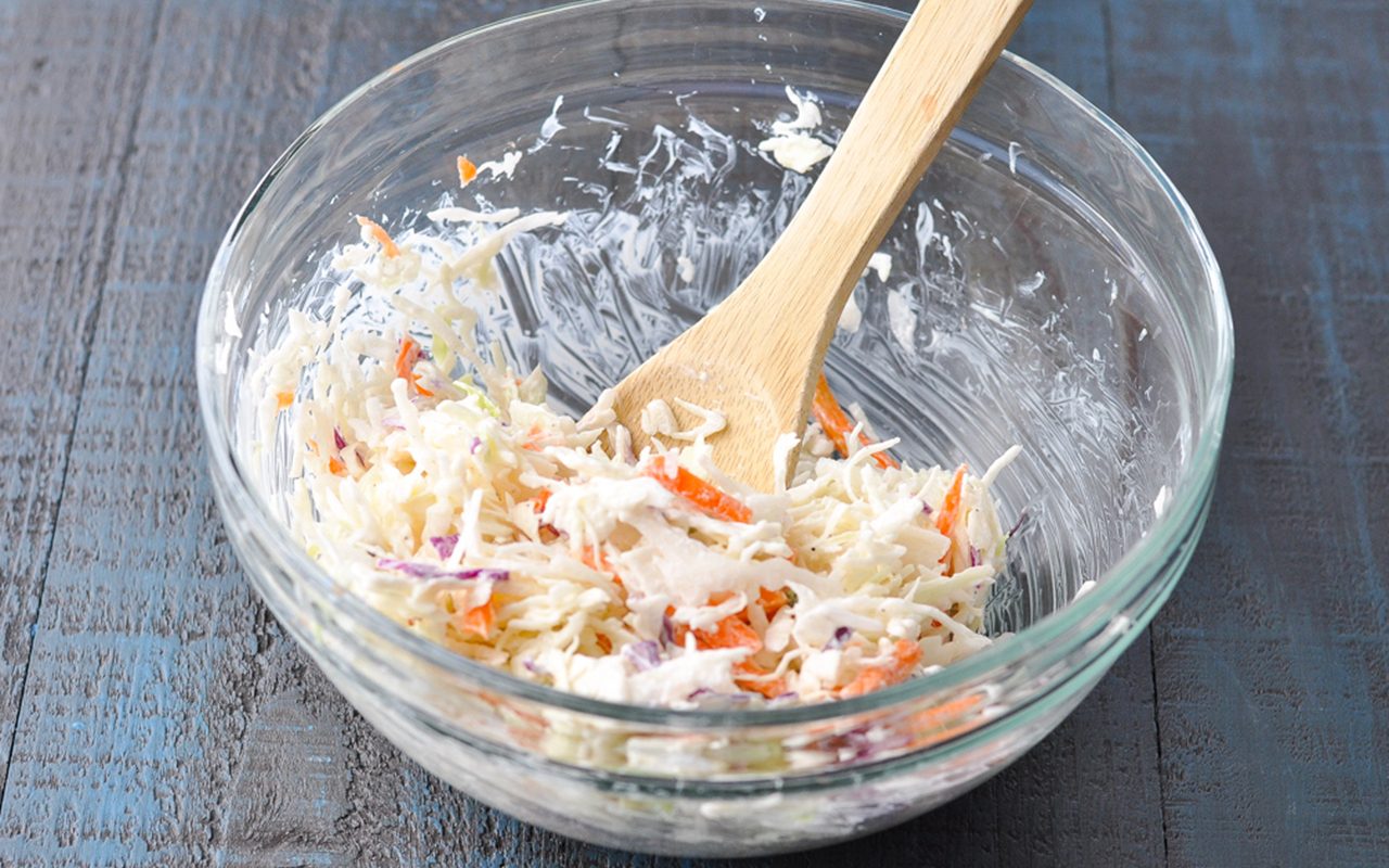 Adding shredded cabbage to whisked mixture