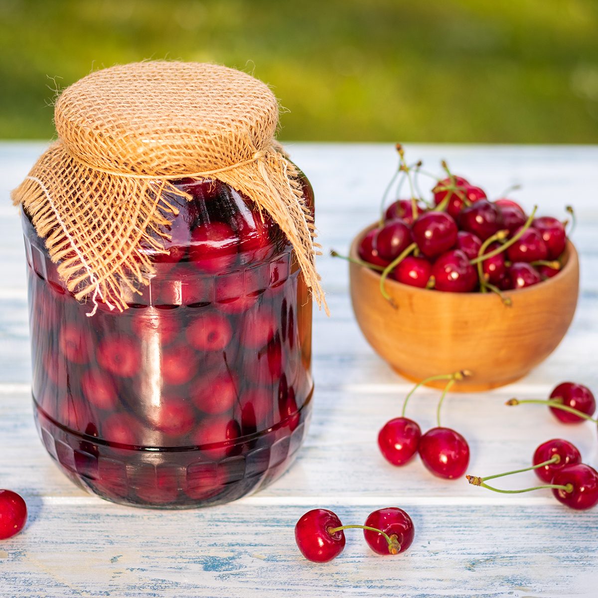 Homemade preserved organic fruits in glass jar. Selective focus, blurry background