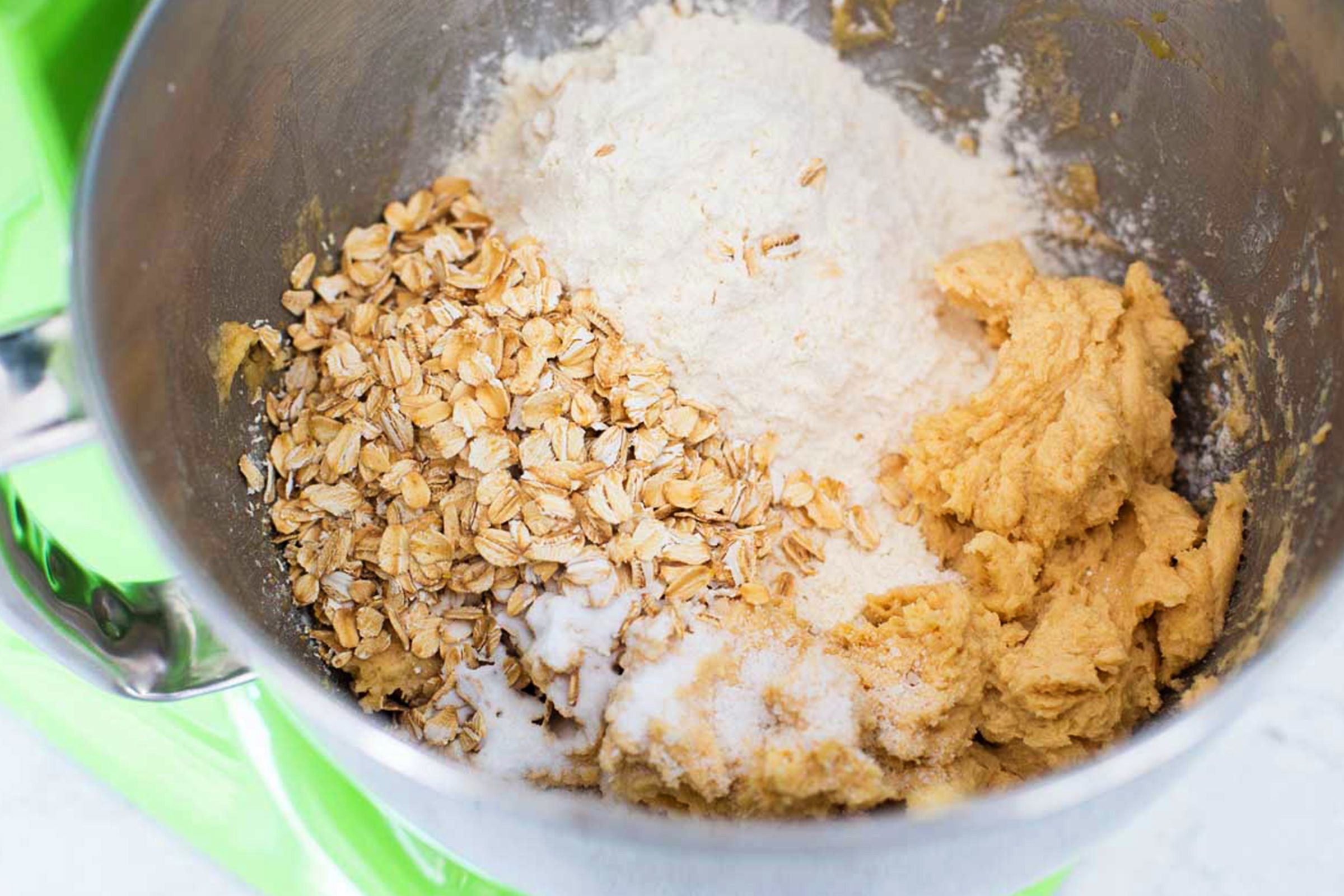 adding dry ingredients to mixing bowl for doubletree chocolate chip cookies