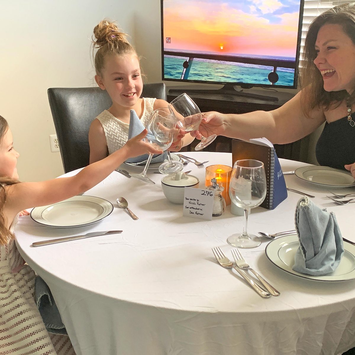 Mother and two kids having a fancy dinner at home