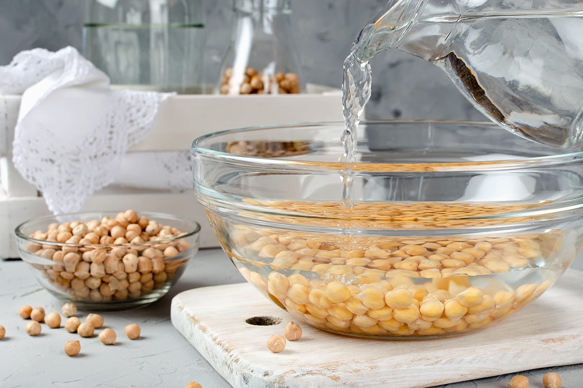 Chickpea soaked in water in a glass bowl. Ingredients for cooking
