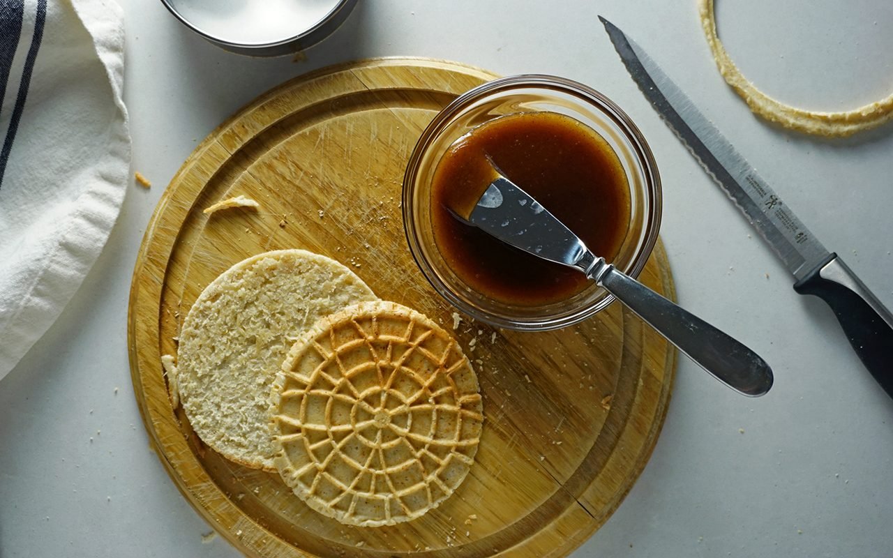 a sliced stroopwafel ready to have maple caramel filling spread on it