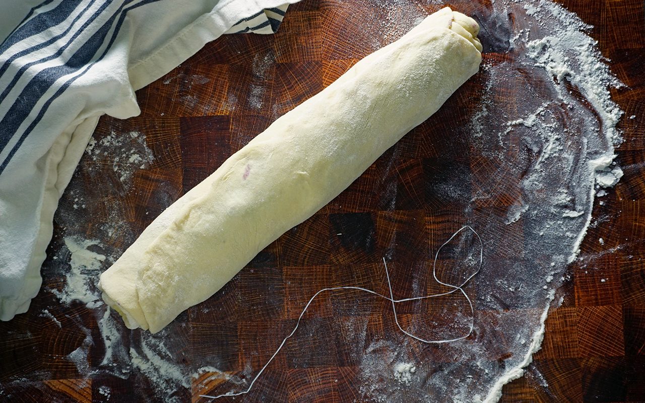 rolled up sweet dough into a log ready for slicing