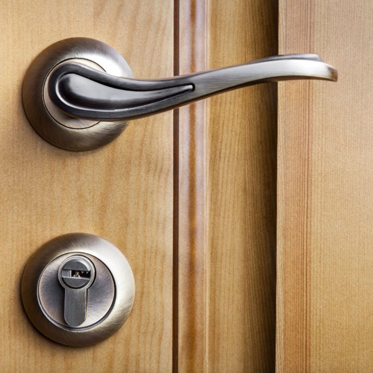 Modern style door handle on natural wooden door