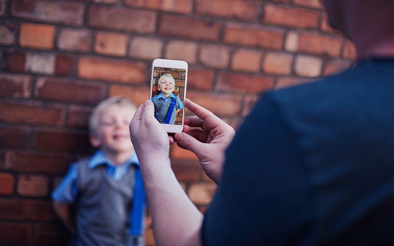 Father at taking a photo of his son.