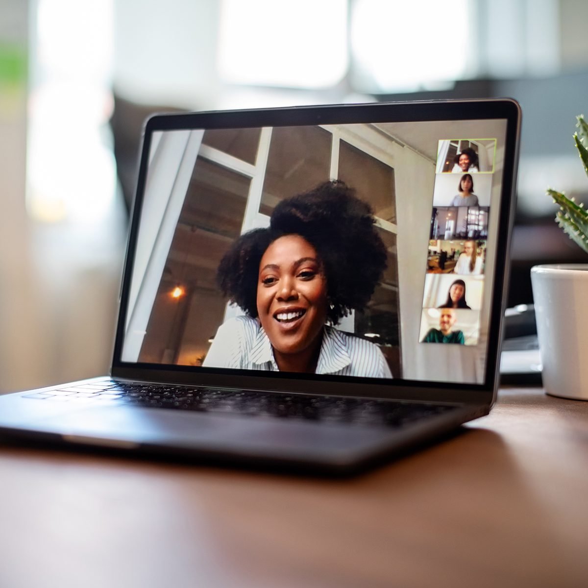 Shot of african businesswoman having a video call on a laptop with her team. Woman having meeting on video call on laptop with diverse colleagues,