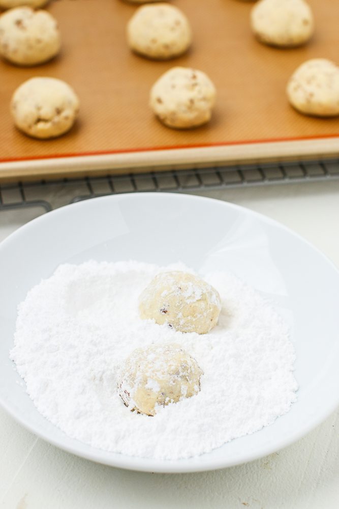 Rolling Cookies in Powdered Sugar - how to make snowball cookies from scratch