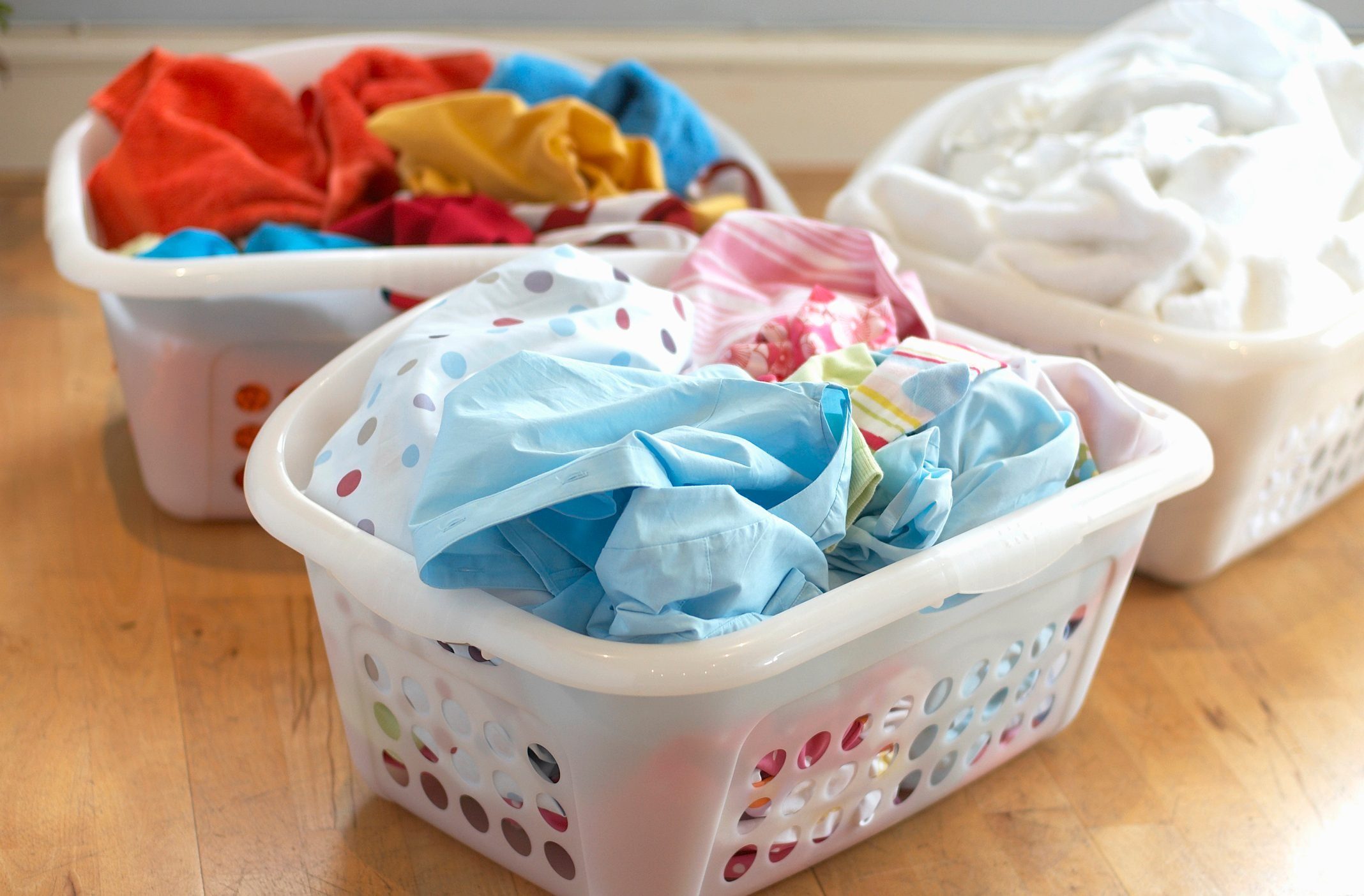 Clean washing in three plastic laundry baskets