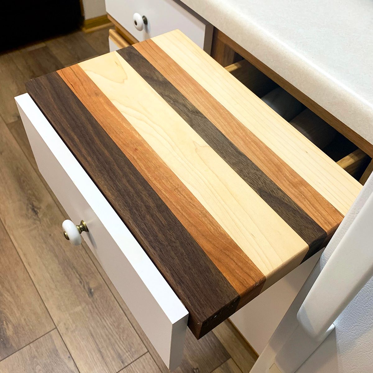 Cutting board resting on top of open drawer