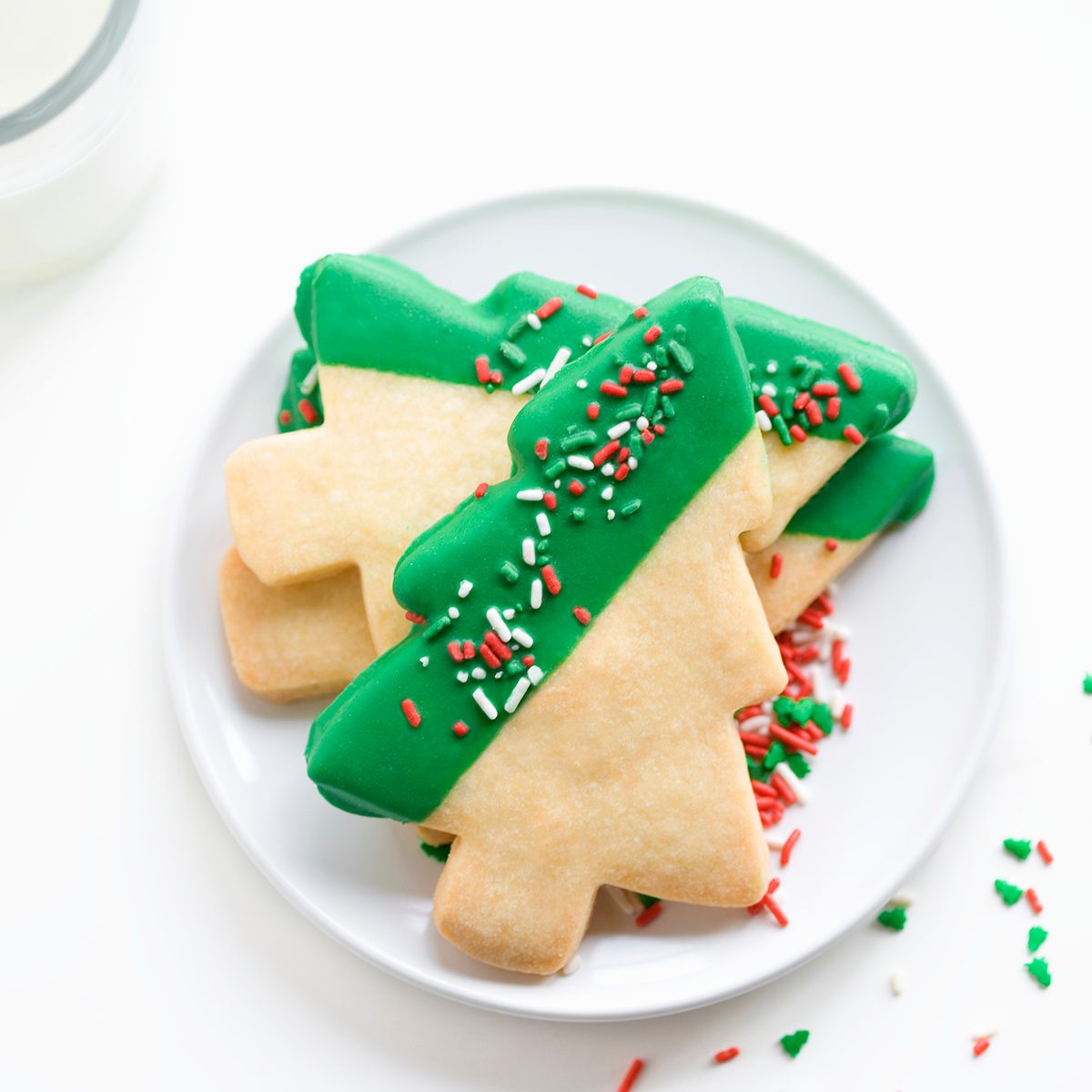 cookie decorating tips Shortbread Christmas Tree Cookies On White Plate With Glass Of Milk