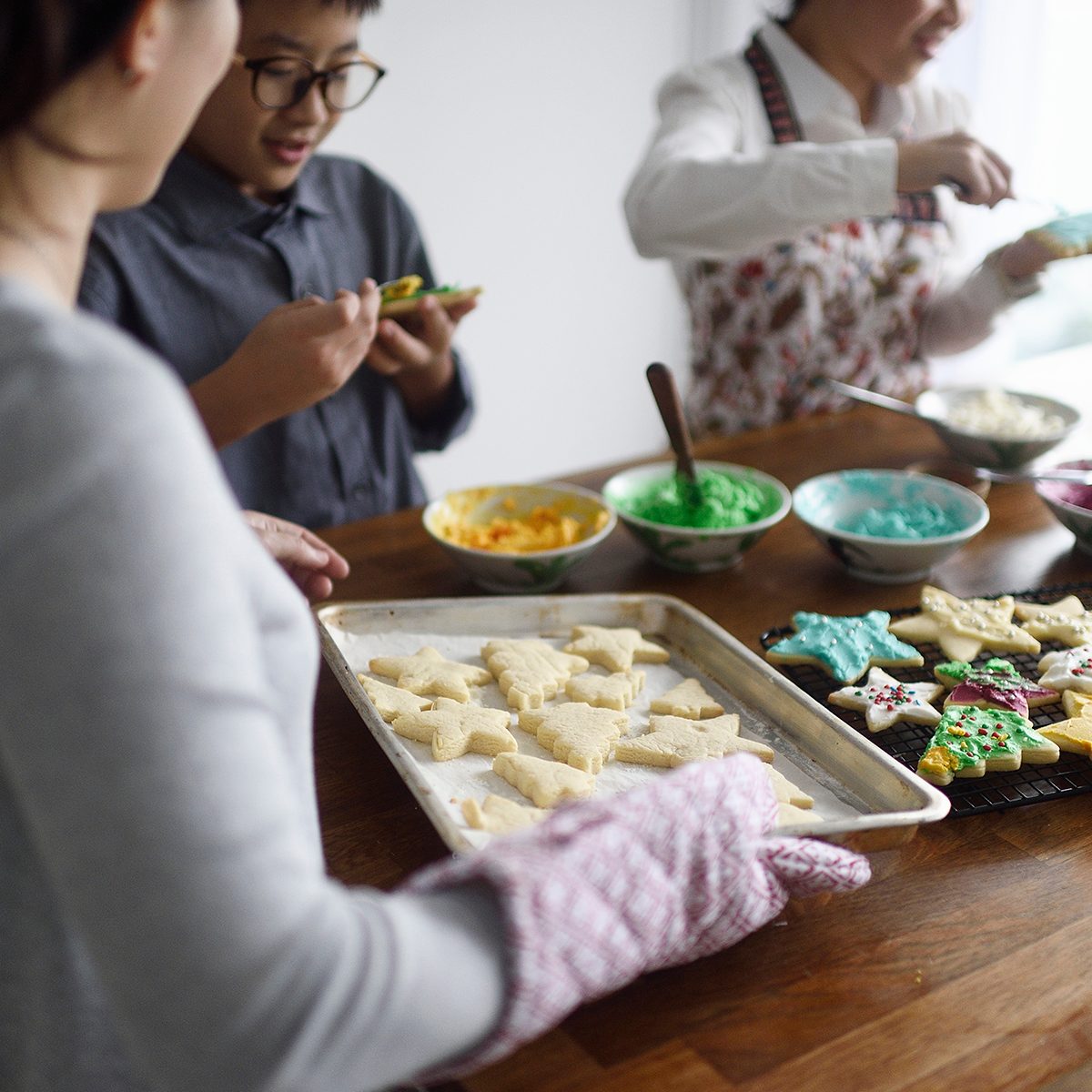 cookie decorating tips Woman Bringing A Fresh Tray Of Cookies To Her Kids Icing