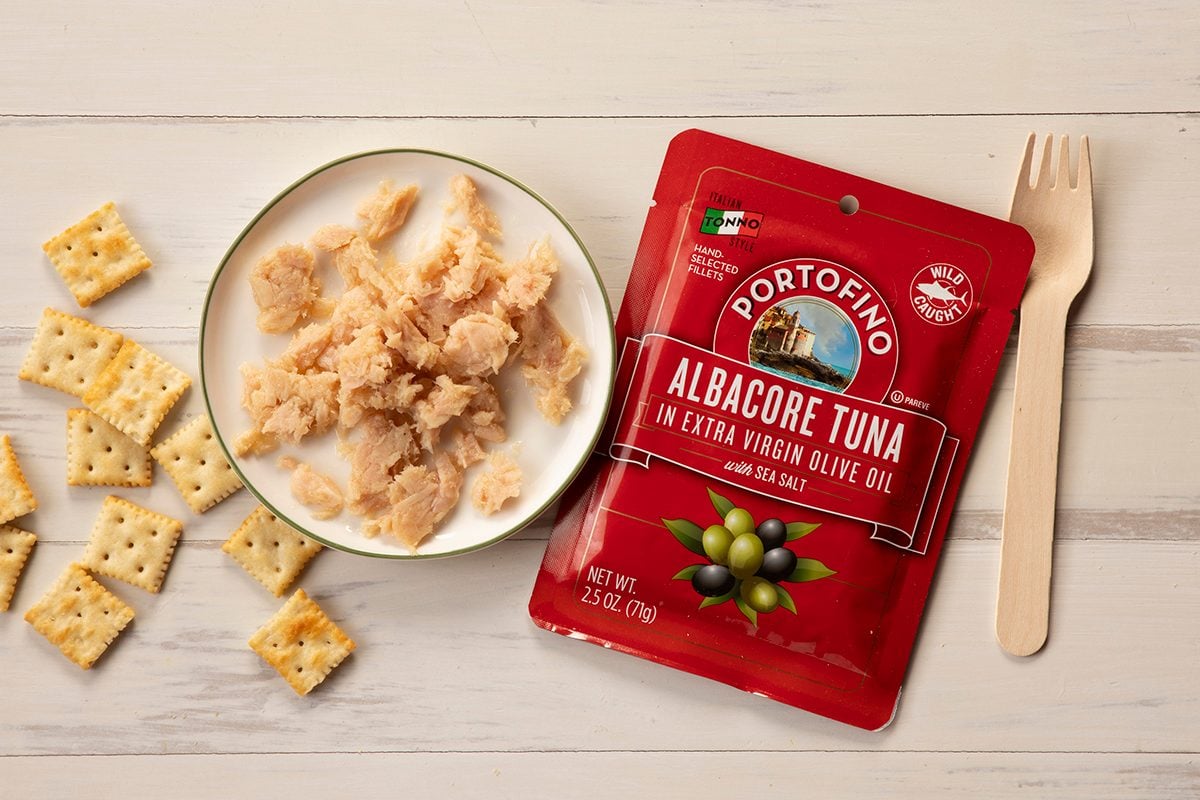 Overhead Shot Of Portofino Tuna In Package And On Plate With Fork And Crackers