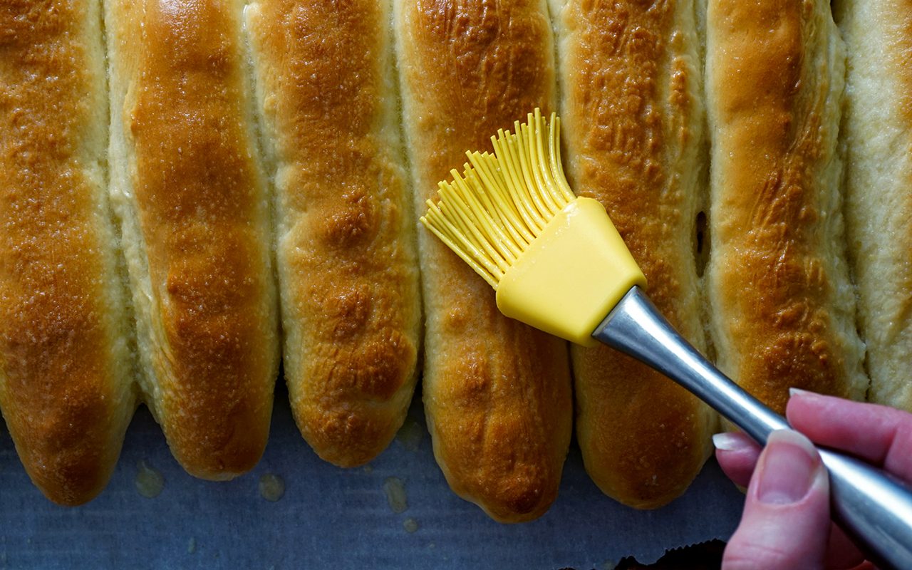 copycat olive garden breadsticks basting olive garden breadsticks with garlic butter after baking