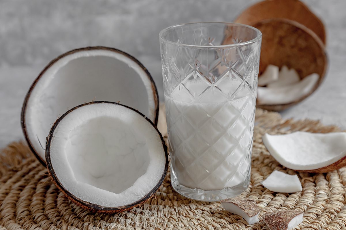 Opened Coconuts, Glass Of Homemade Coconut Milk And Coconut Chunks