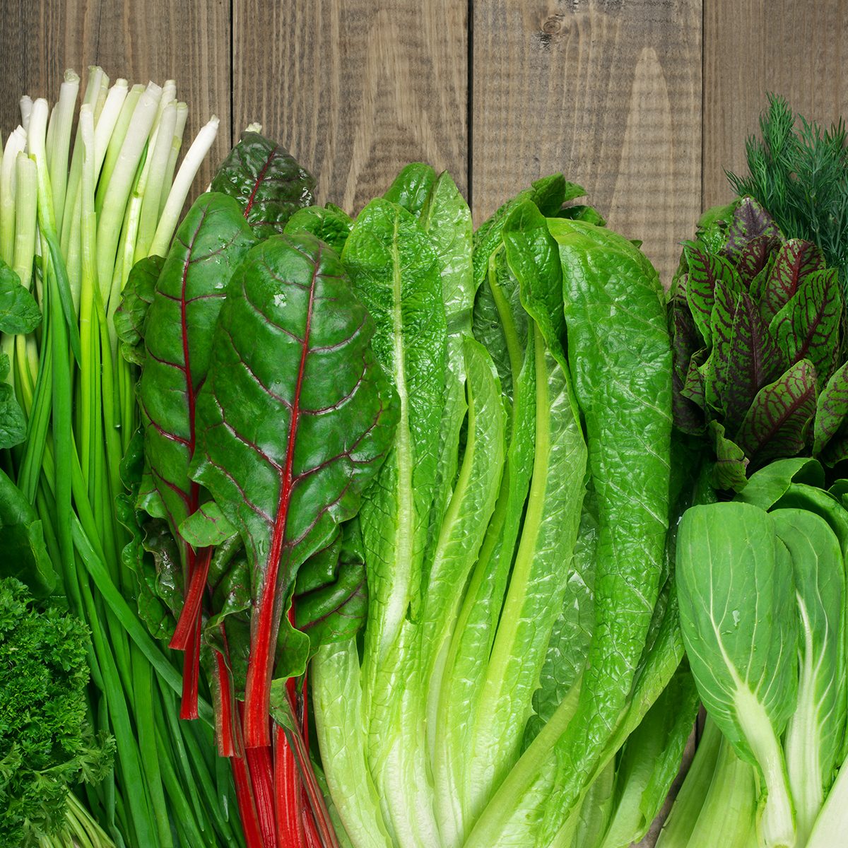 prediabetes foods to avoid Spring vitamin set of various green leafy vegetables on rustic wooden table. Top view point.