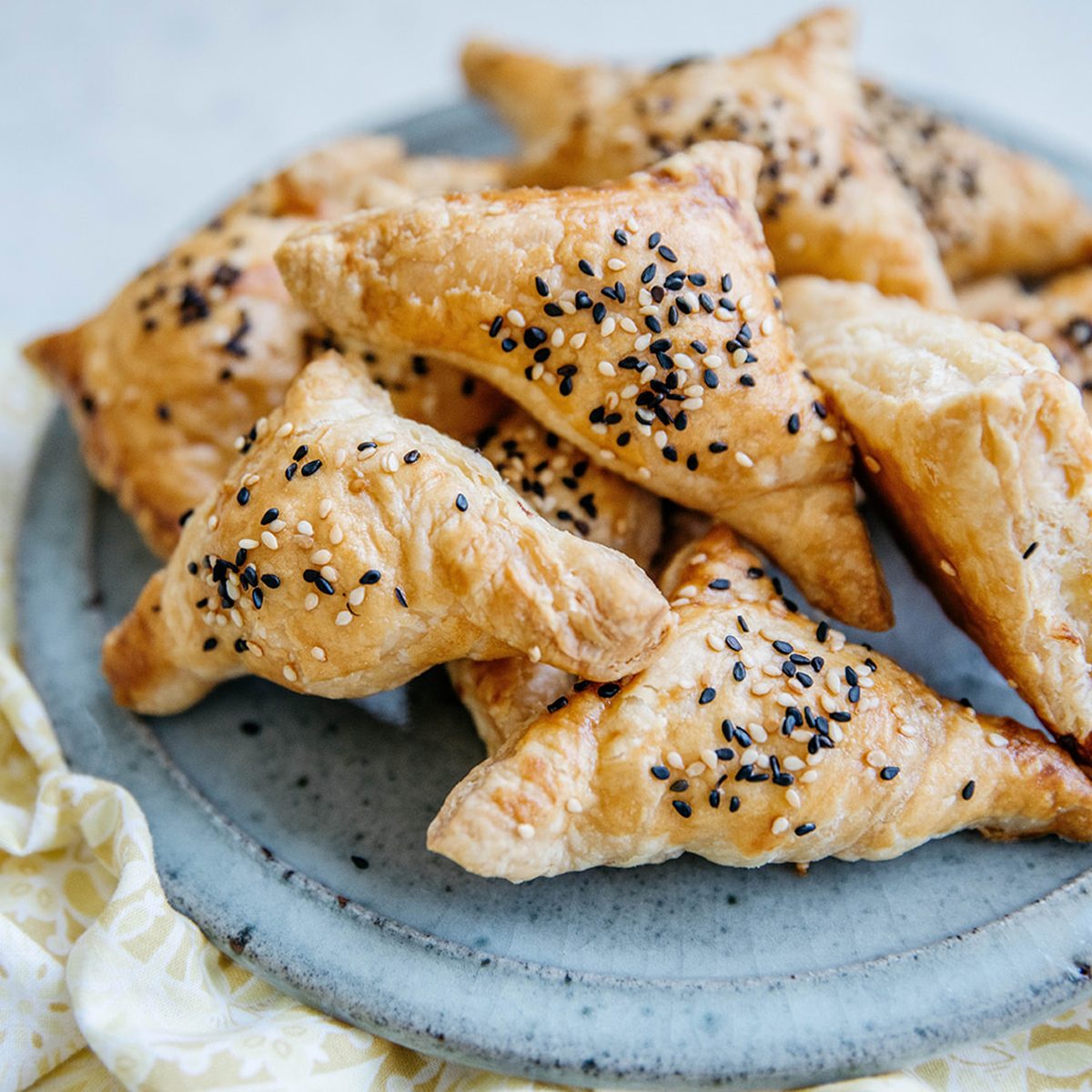 Cheese-stuffed bourekas with white and black sesame seeds