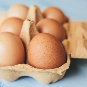 Eggs Background Closeup View Of Eggs In Carton Box On Wooden Table