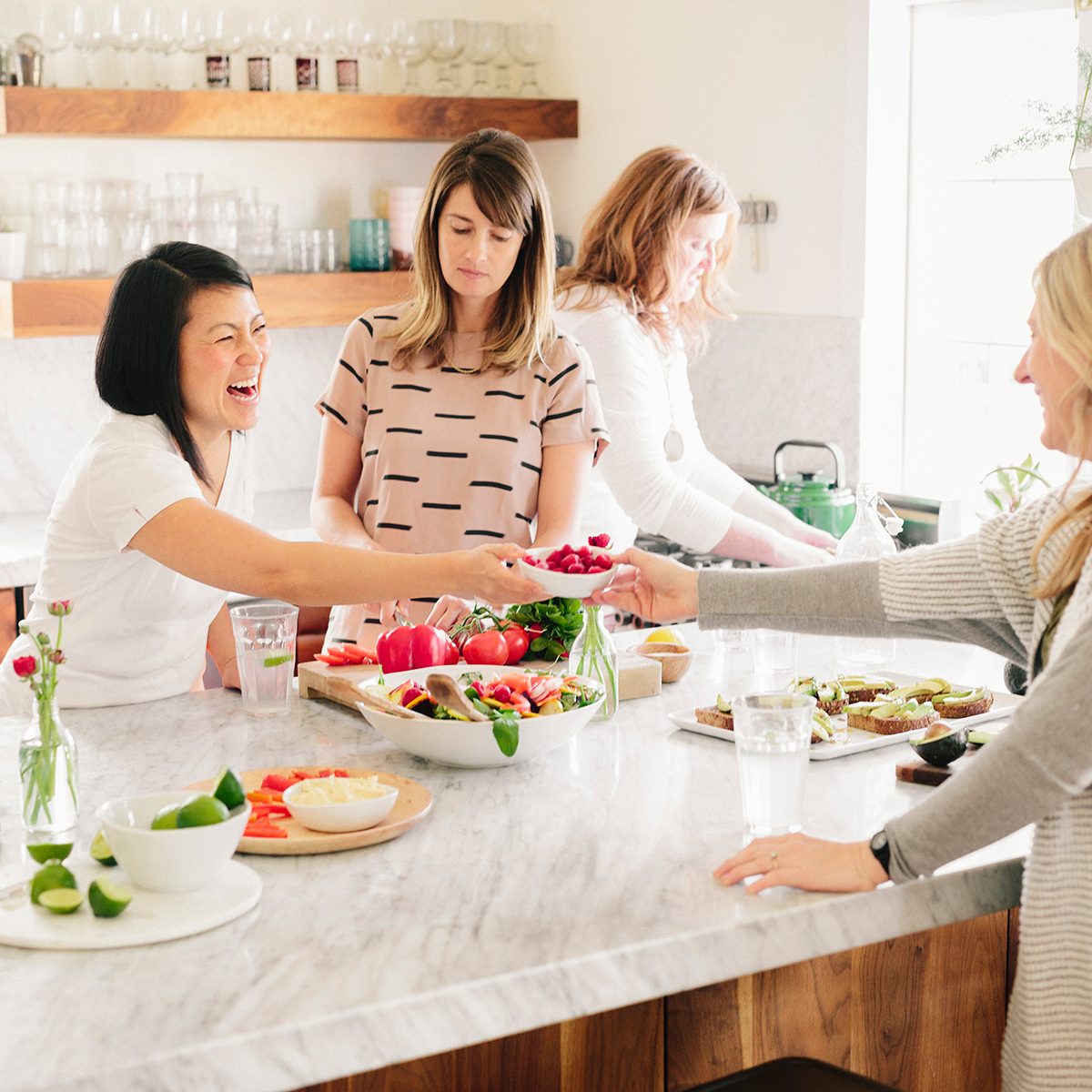 how to keep food cold outside Four Women In A Kitchen Preparing Lunch.