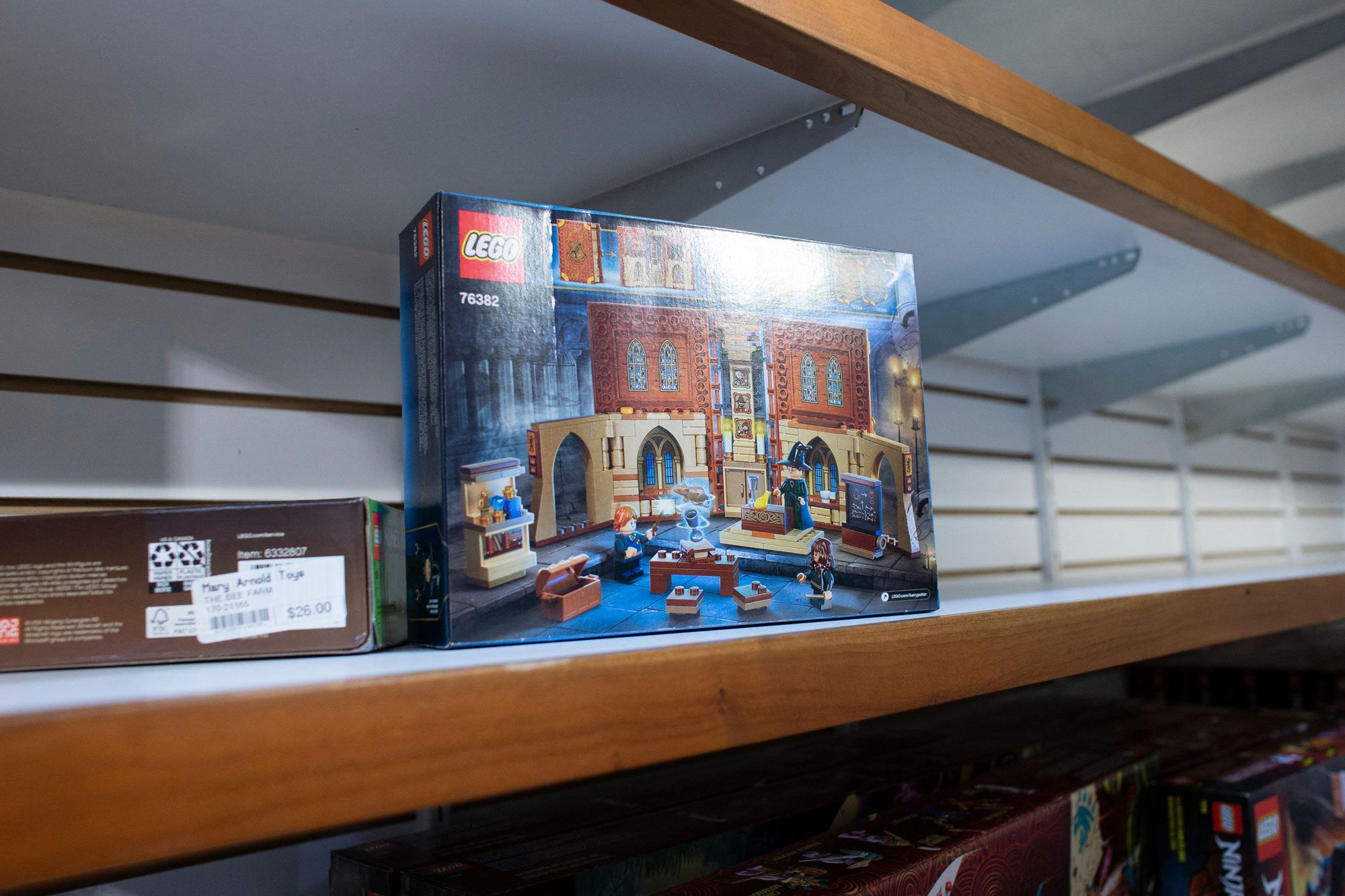 a shelf of toys with only a few items left; mostly empty shelf in toy store